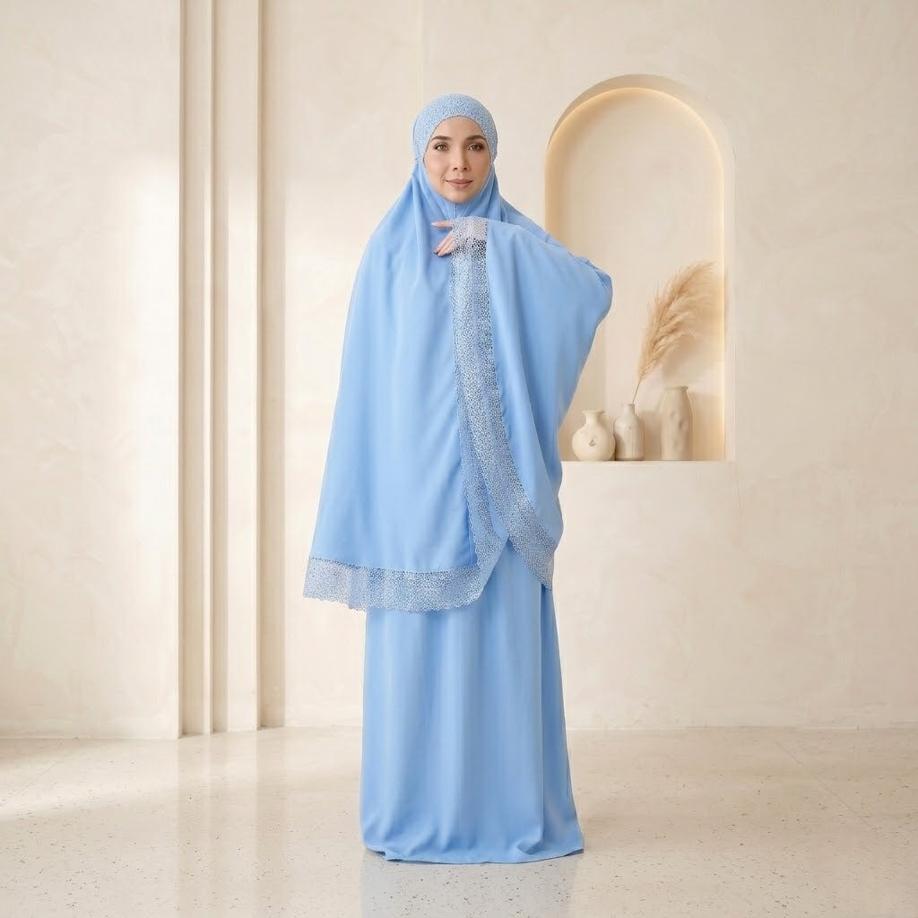 Woman wearing a light blue hijab and dress in a neutral setting